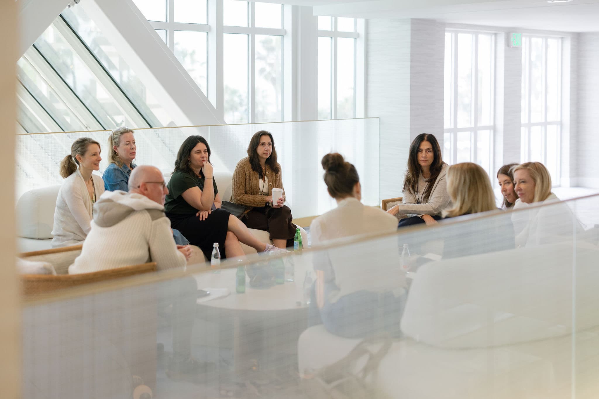 A group of travel advisors in conversation around a table