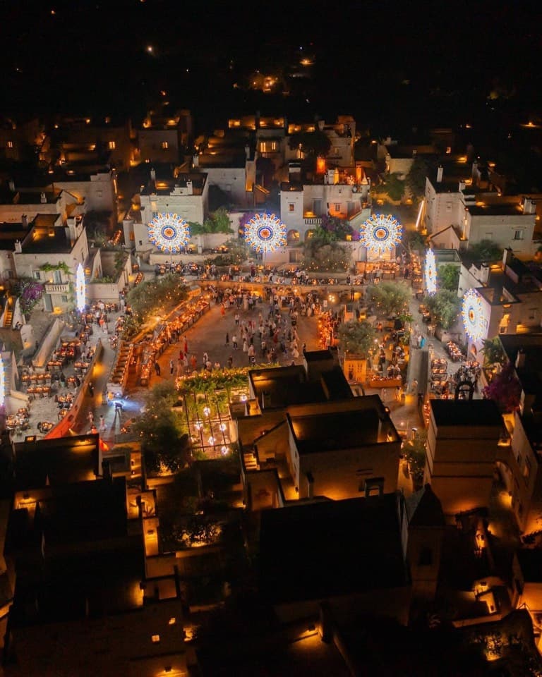 A lit village square seen from above at night